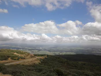 A view from Whariti Peak looking down on farm land and windmills