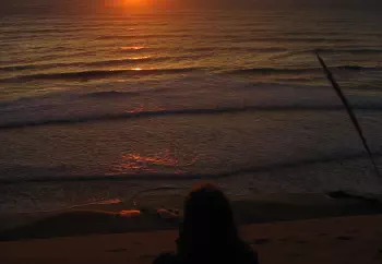 Josephine Fahy watching the sun rise over the waves at Castlepoint